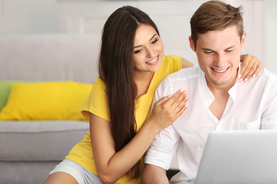 Couple Using the Laptop Indoors